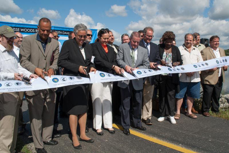 Friends' President Benjamin Cox helps cut the ribbon for the Busse Dam Reservoir Project.