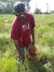 Tyrone Murdo collects native seeds at Dolton Prairie for planting later in the year.