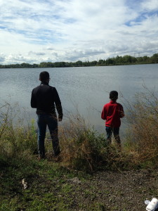 Eduardo Paz helps teach a youngster how to fish at one of our free recreation events in the Calumet.