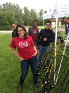 Gloria Orozco helps teach young kids how to fish at one of our free recreation events in the Calumet.