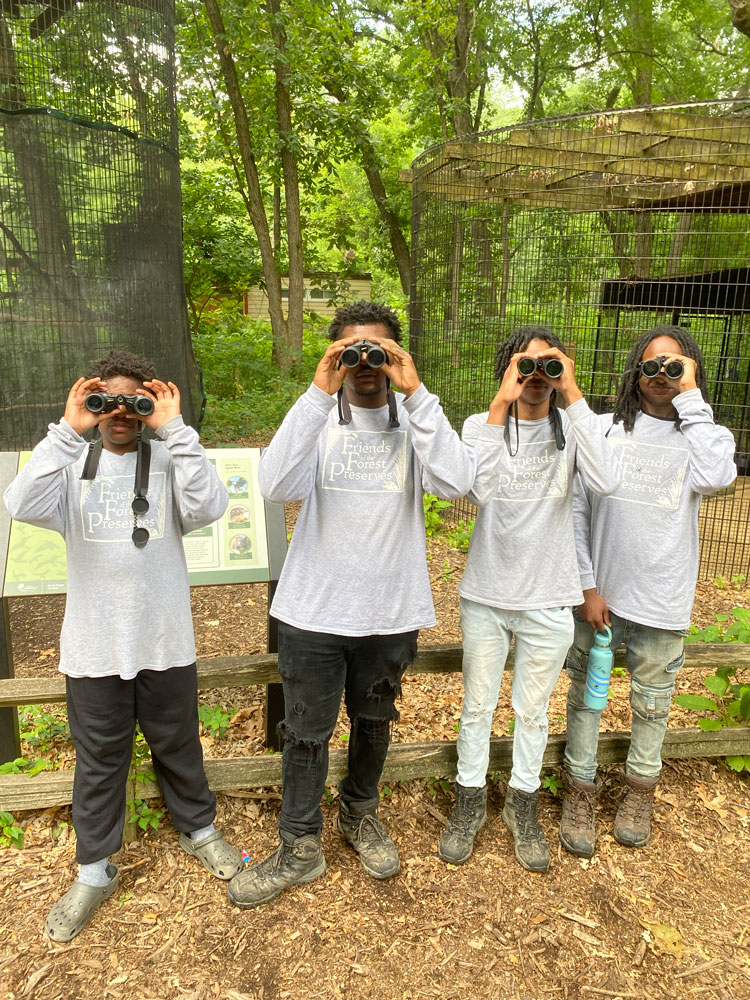 Daron Marquize Torian Kitrell with binoculars at sandridge nature center